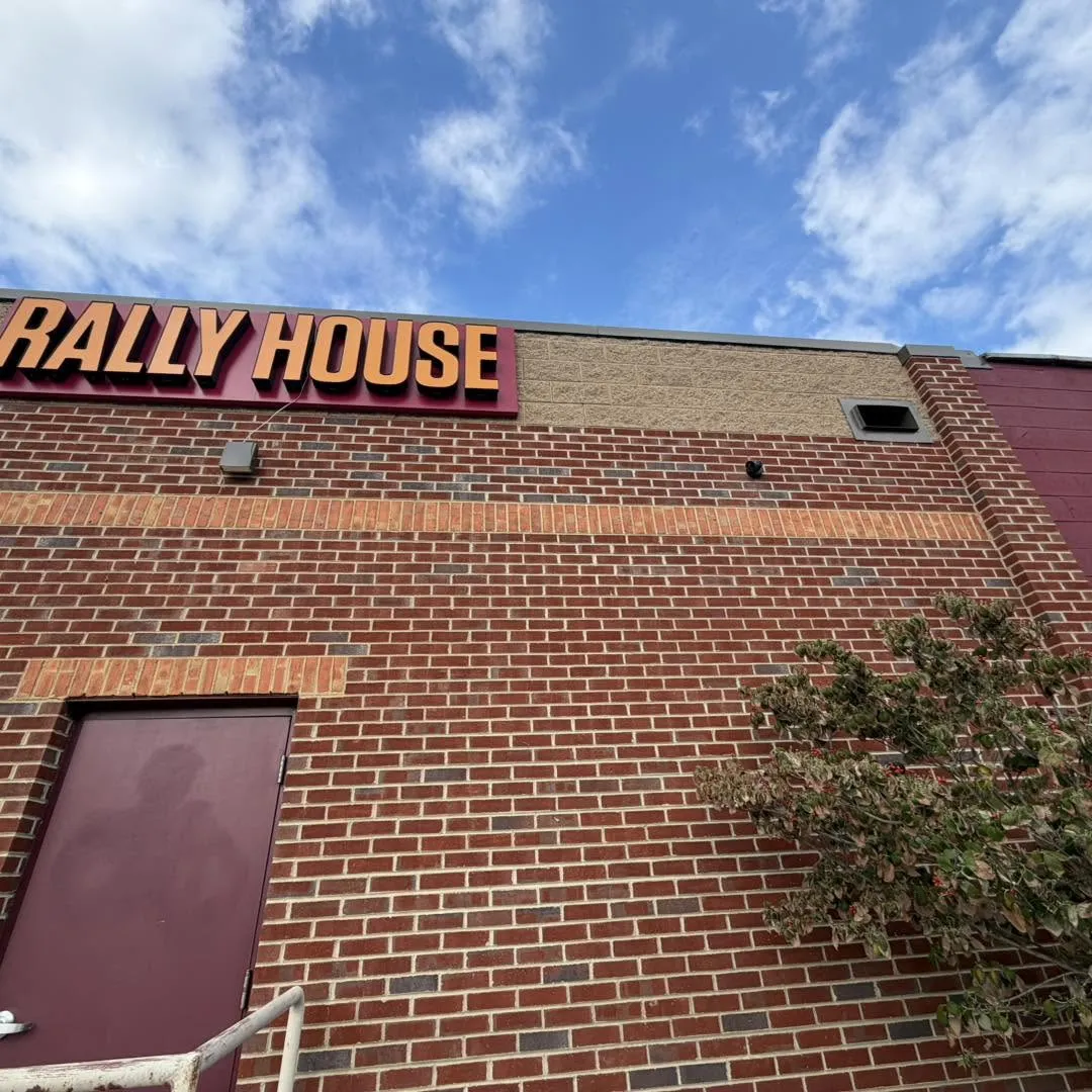 Rally House commercial surveillance camera installation by Zaxx Tech Solutions beside the store sign