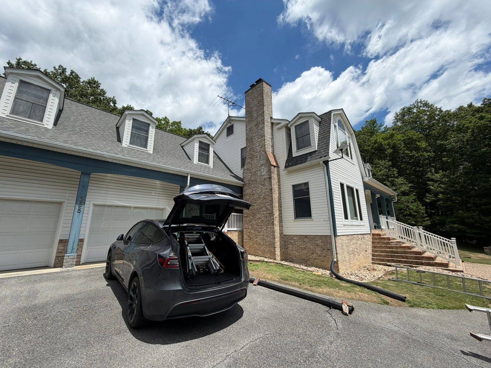 Starlink installation in progress at a large Virginia home with equipment staged from the install vehicle
