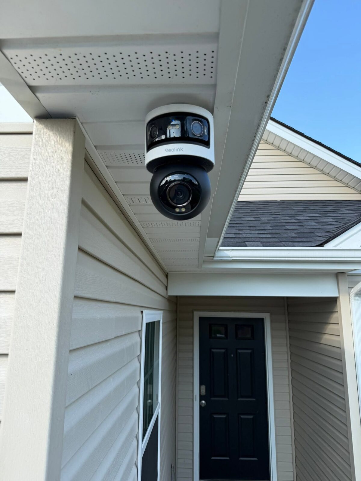 Reolink dual-lens security camera mounted under an eave by Zaxx Tech Solutions