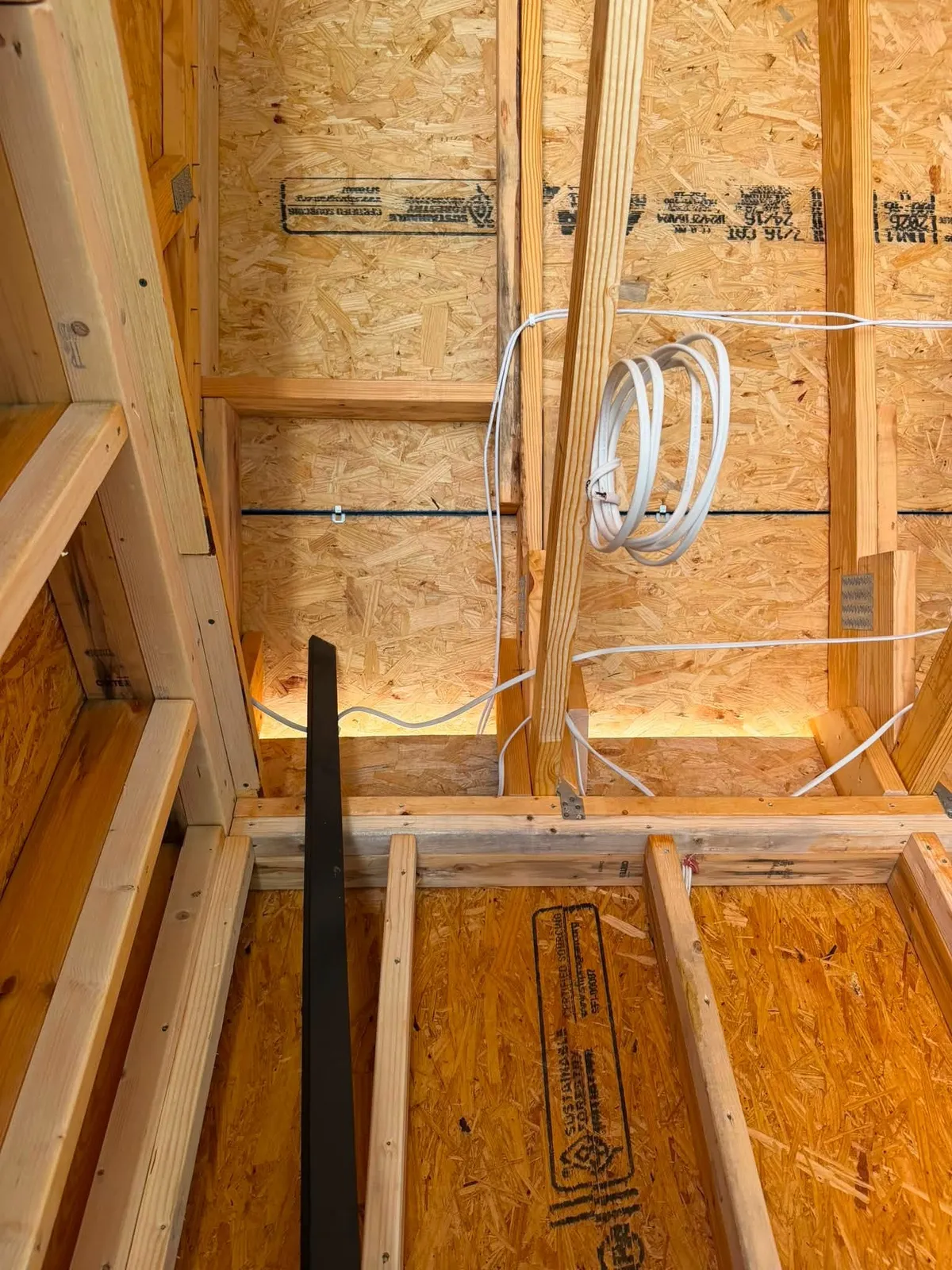 Coiled cable service loop left in the ceiling framing of a Rocky Mount Virginia new construction home