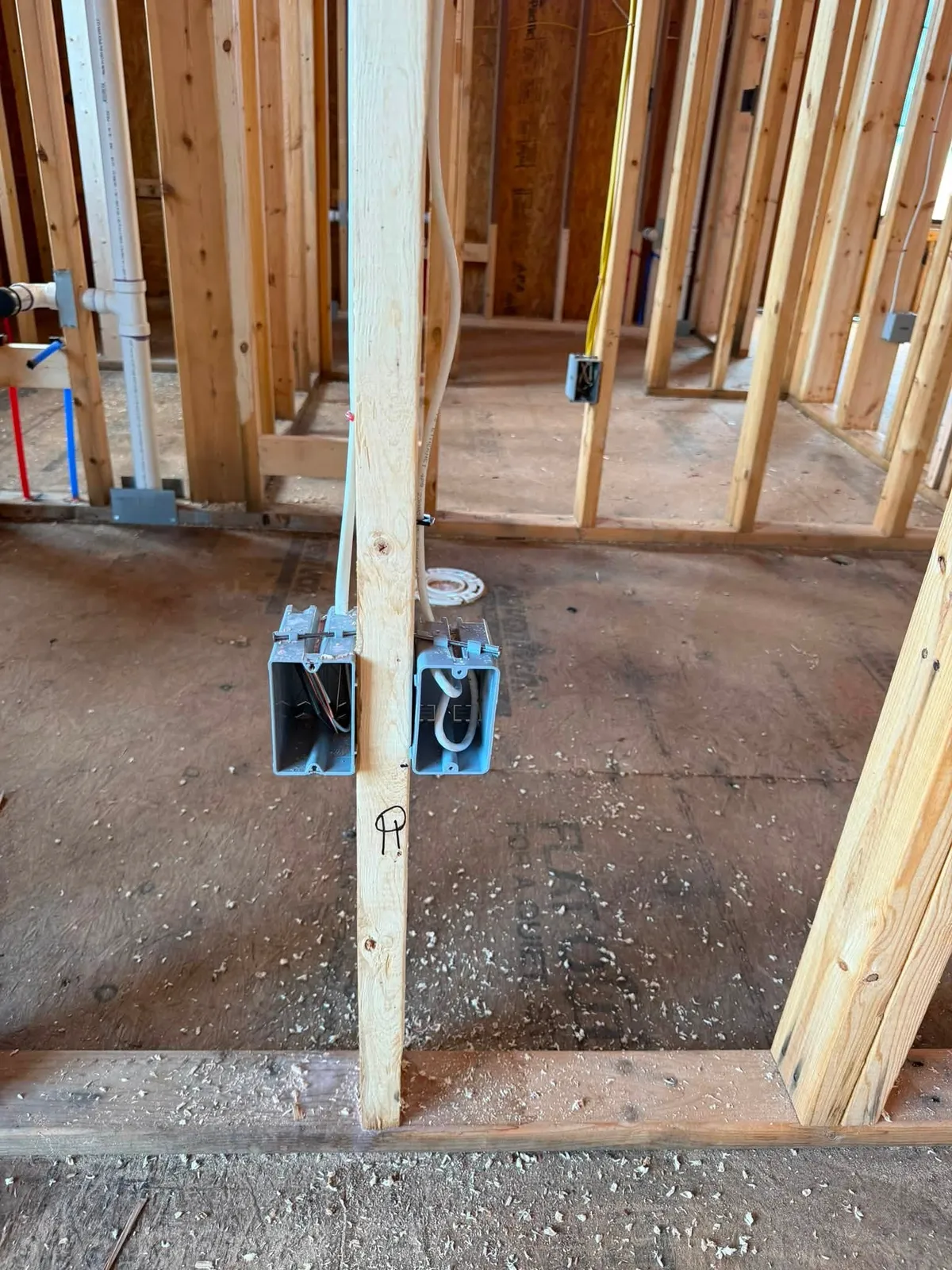 Low-voltage boxes and structured cabling roughed in on the open framing of a Rocky Mount VA new construction home