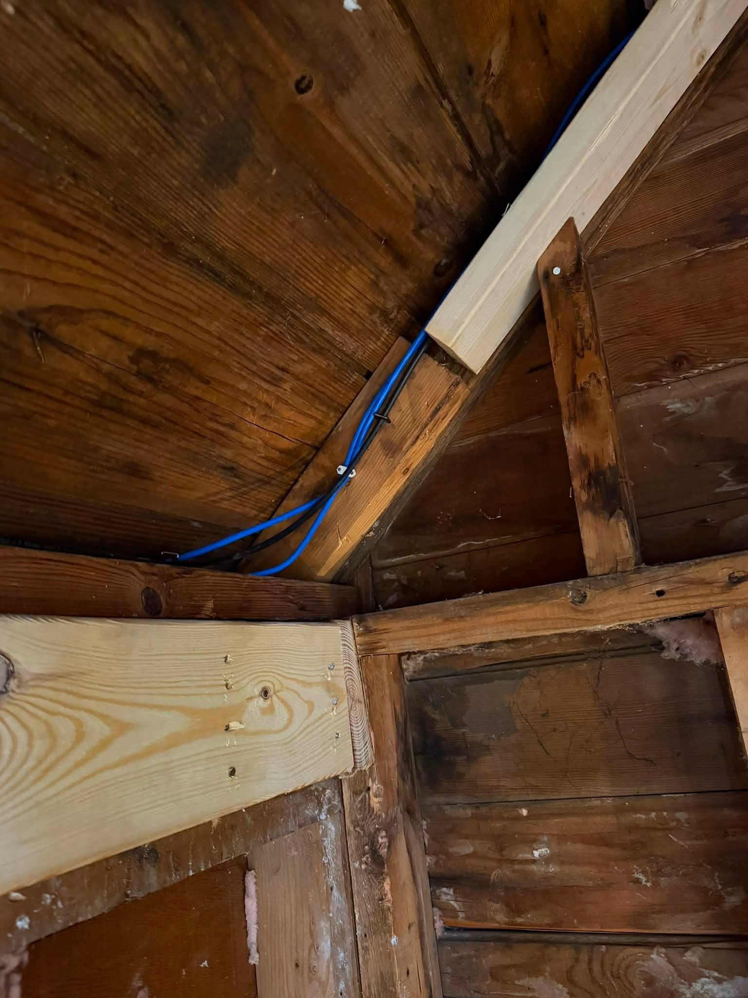 Cat6 cables stapled and routed neatly through a ceiling corner during a home pre-wire