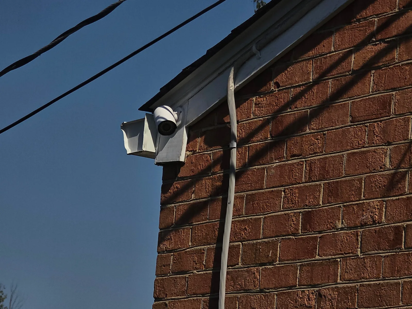 Reolink security camera mounted at the corner of a brick gable on a Salem, Virginia home