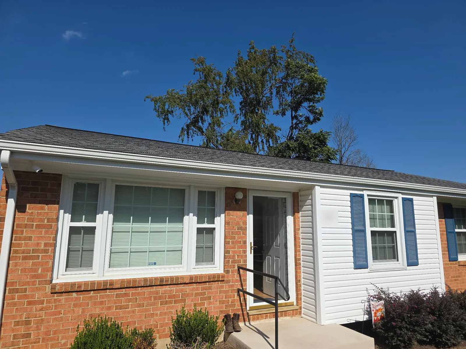 Front of a brick home in Salem, VA with a security camera mounted under the roofline by Zaxx Tech Solutions
