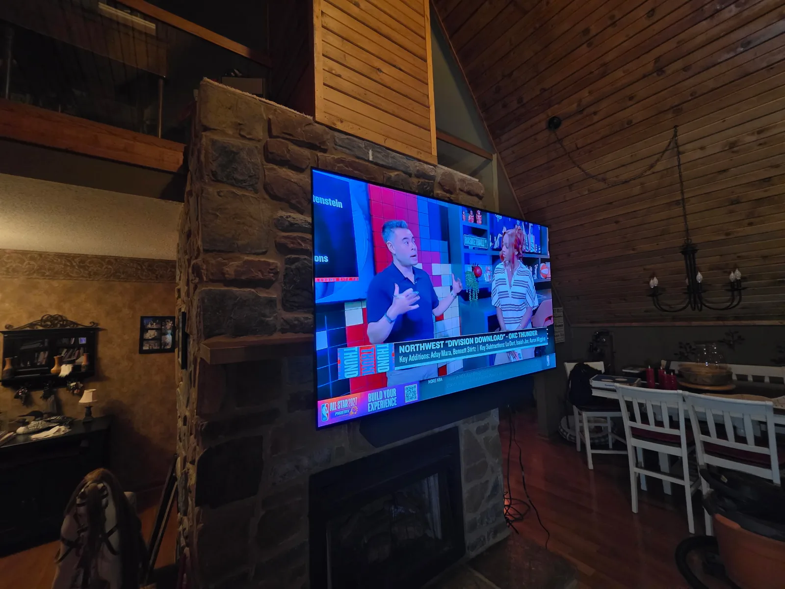 Large-screen TV mounted on a natural stone fireplace in a vaulted-ceiling lake home at Smith Mountain Lake, VA