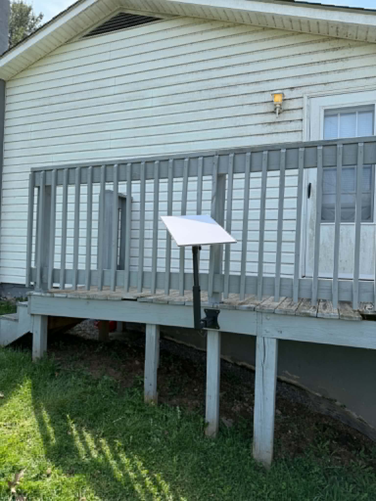 Starlink dish on deck railing — side angle