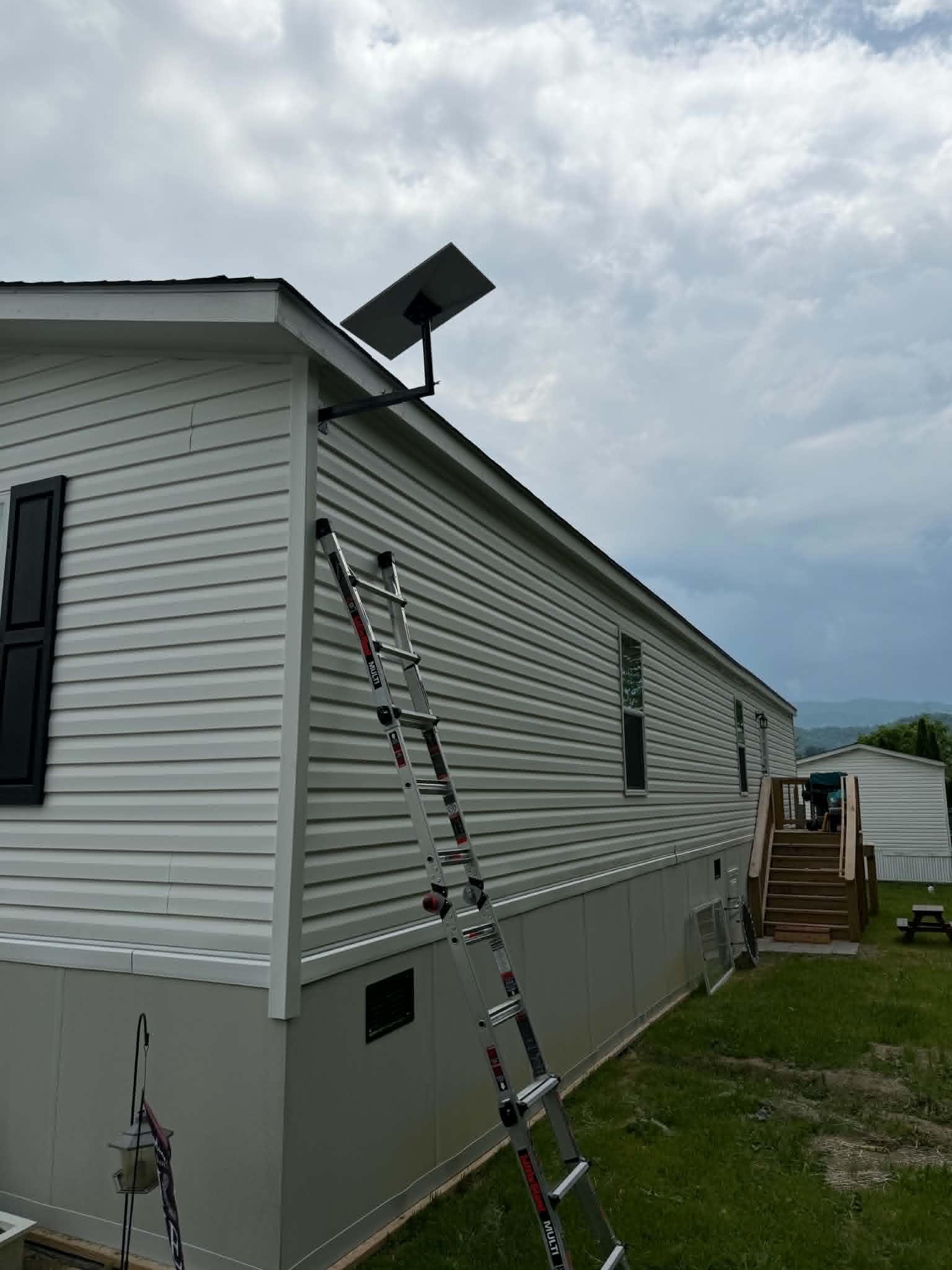 Starlink installation with ladders — mountain view